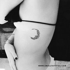 a woman's stomach with a small tattoo on her belly and the letter c