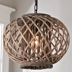 a wooden light fixture hanging from a ceiling