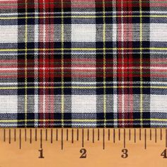 a ruler is next to a plaid fabric that has been made in different colors and patterns