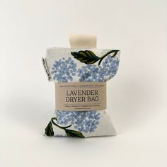 lavender dryer bag with blue flowers and leaves on the front, sitting on a white background