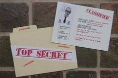 two pieces of paper with the words top secret on them next to a brick wall