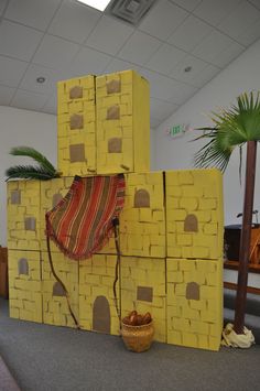 a building made out of cardboard blocks with a blanket on top