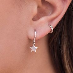 These Earrings are Sterling Silver Hoops with a hanging star. They are earrings that feel great for day to day or for a special occasion. They are modern and minimalist in style and you can wear them both on the earlobe and on the cartilage. You can buy the earrings in sterling silver or silver with a gold plating. Features: 925 sterling silver silver or gold plated Diameter: 11mm nickel free. If you have any questions, do not hesitate to contact us, we will be happy to assist you! Gothic Jewellery, Hanging Star Earrings, Dainty Silver Earrings Aesthetic, Small Silver Hoop Earrings, Silver Star Earrings, Dagger Earrings, Earrings Aesthetic, Gothic Earrings, Girly Jewelry