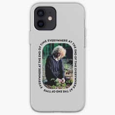 an old woman with white hair is sitting in the woods iphone case / skin cover