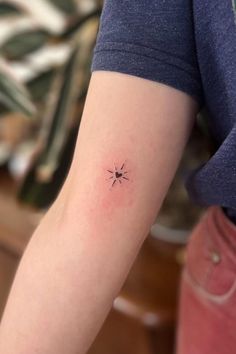 a person with a small star tattoo on their arm