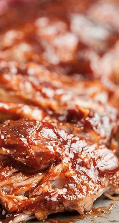 ribs covered in bbq sauce sitting on top of a cutting board