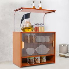 an open cabinet with spices and condiments in it next to a canister