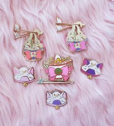 four pin badges sitting on top of a pink furry surface