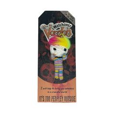 a small toy with a rainbow hair on it's head in a card box