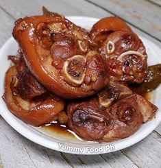 some food on a white plate sitting on a wooden table and ready to be eaten