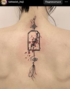 the back of a woman's neck with a tattoo on it