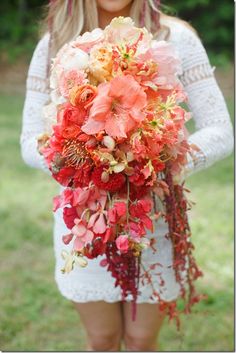 a woman holding a bouquet of flowers in her hands