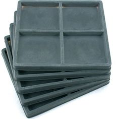 four square trays are stacked on top of each other, one is black and the other is gray