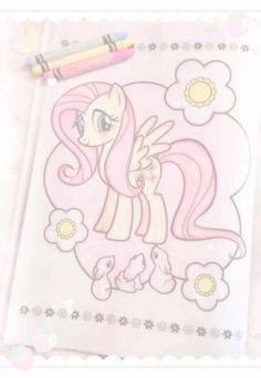 an image of a pinkie pony with flowers on it's face and two crayons next to it