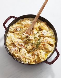 a skillet with some food in it and a wooden spoon