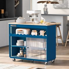 a blue kitchen cart with dishes on it