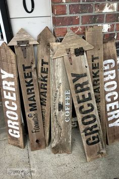 some wooden signs that are sitting on the ground