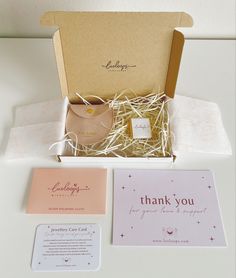 an open gift box containing a card, envelope and thank you note with the message written on it