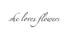 the words she loves flowers written in black ink