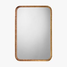 an antique mirror with gold trimmings on the edges and a wooden frame, against a white background