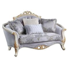 an ornately decorated couch with pillows on it's back and arms, sitting in front of a white background