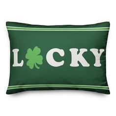 a green and white pillow with the word lucky on it