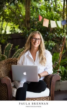 a woman sitting in a chair with a laptop