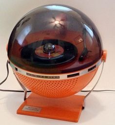 an orange and black record player sitting on top of a table