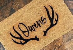 a door mat with the word queens on it and an antler's head