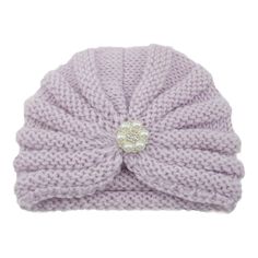 a white knitted hat with pearls on the top and a knot at the bottom