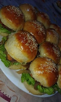 a plate filled with rolls covered in sesame seeds