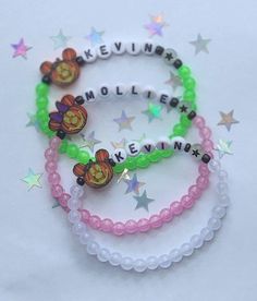 three bracelets with charms on them that say believe, molliene, and minnie