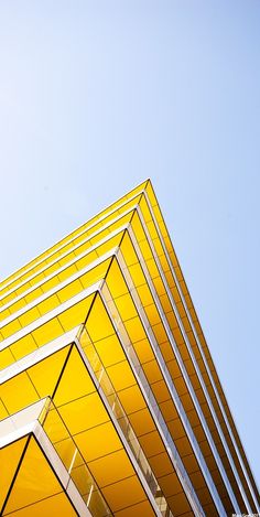 the top of a yellow building against a blue sky