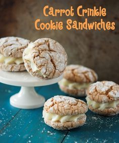 carrot crinkle cookie sandwiches with icing on a cake stand and blue background