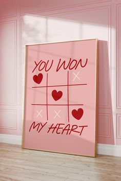 a valentine's card with the words you won my heart on it in front of a pink wall