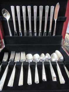 an assortment of silverware in a case