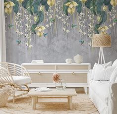 a living room with white furniture and flowers on the wall