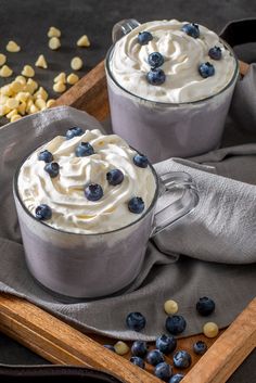 two glasses filled with blueberry white hot chocolate