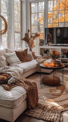 a living room filled with furniture and a fire place in front of a tv mounted on a wall