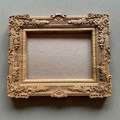 an ornate gold frame hanging on the wall