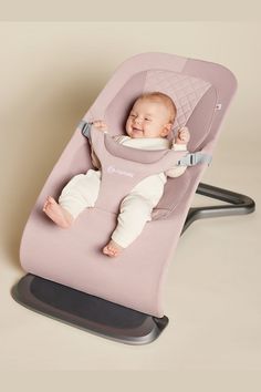 a baby is sitting in a pink highchair