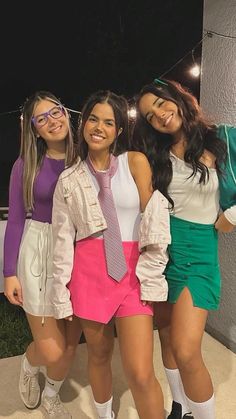 three girls are dressed up and posing for the camera