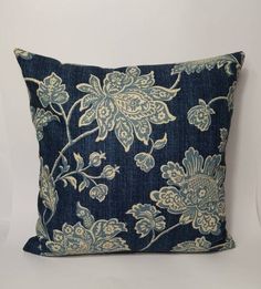 a blue and white pillow with flowers on it