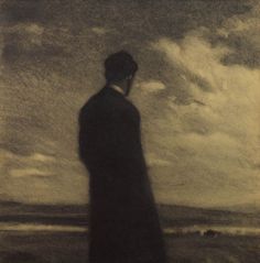 a man standing in front of a cloudy sky