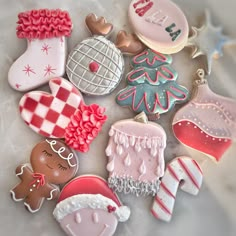 many decorated cookies are laying on the table