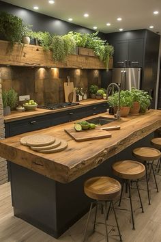 a large kitchen with an island and wooden counter tops, surrounded by potted plants