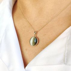 This stunning pendant is set in 14k Solid Yellow Gold with Natural Chrysoberyl Cats Eye with utmost precision. It is an unique gemstone pendant for nearly every occasion and is completely hassle-free jewelry. ITEM DETAILS: * Gem: Chrysoberyl (Cats Eye) * Gem Size: 12X12.5mm * Gem Shape: Oval * Gem Weight: 7.82 carats * Gold Purity: 14KT  * Gold Weight: 0.54 gram * Total Weight: 2.10 gram The Gold purity is guaranteed and it comes with authentic 14KT gold hallmark. Since my items are handmade, th Faceted Oval Pendant Necklace For Gift, Gold Agate Oval Pendant Necklace, Elegant Cat Eye Gemstone Jewelry, Cats Eye Gem, Artisan Agate Oval Pendant Necklace, Cat Eye Jewelry, Cat Eye Necklace, Elegant Pendant Necklace With Cat Design, Eye Gems