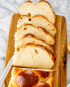 sliced loaf of bread sitting on top of a cutting board