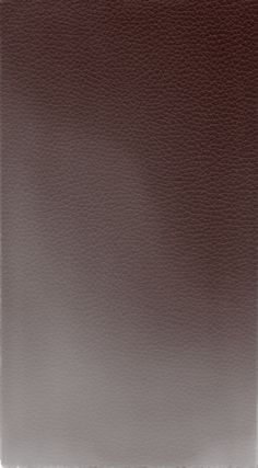 a brown leather textured surface with white stitching