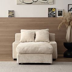 a white chair sitting in front of a wooden headboard